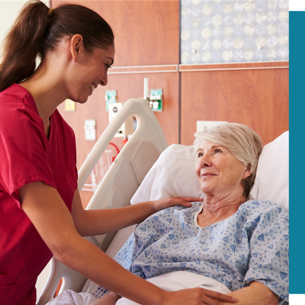 caregiver assisting woman in hospital bed