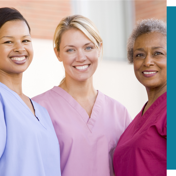 three caregivers in scrubs standing together
