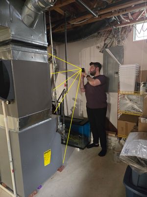  The photo captures a furnace in the basement, front view.