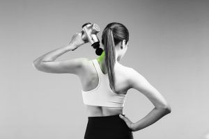 a woman using a pulse gun on her neck