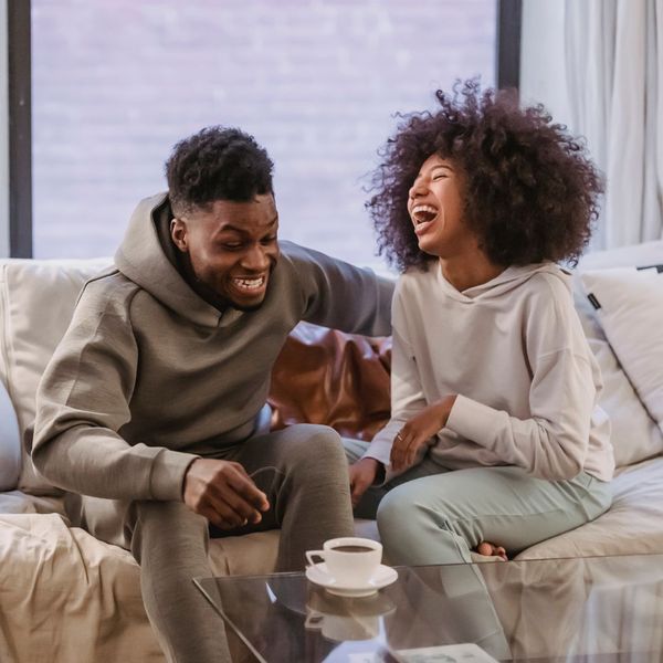 happy couple laughing on couch