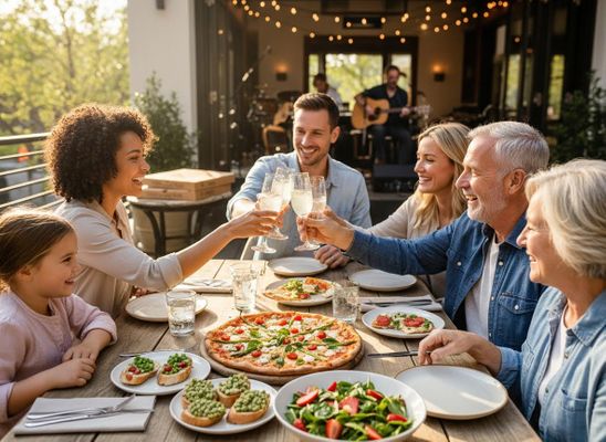 Happy family celebrating at an outdoor restaurant, making a toast with drinks over a table with pizza and salads, live music in the background. Multi-Generational Family Toasting Outdoors