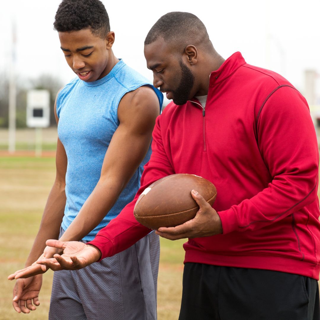 coach teaching a young person