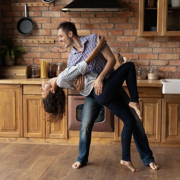 young couple dance in their kitchen