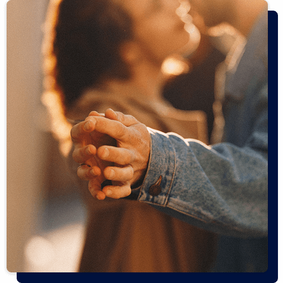 an image of a couple holding hands and dancing