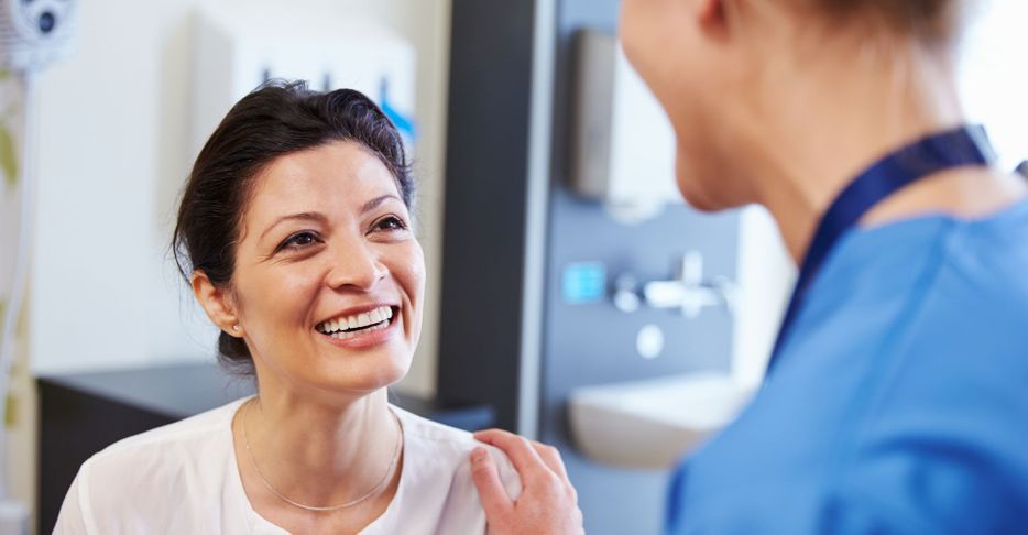 doctor talking with smiling patient