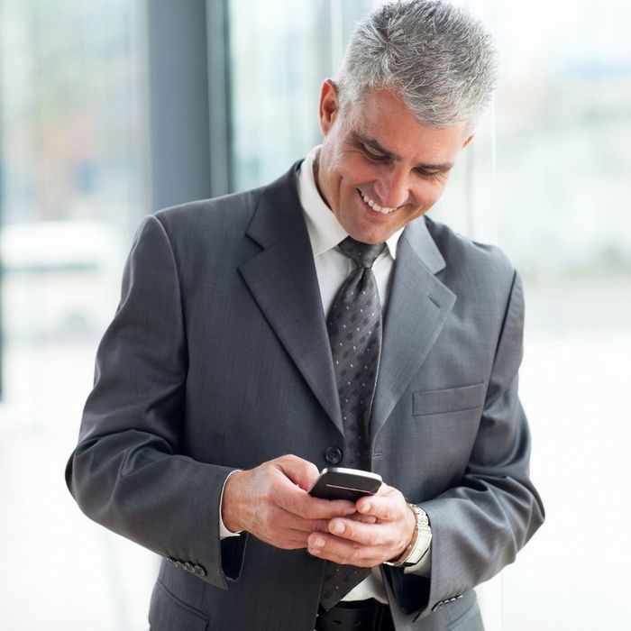 happy middle-aged man using phone