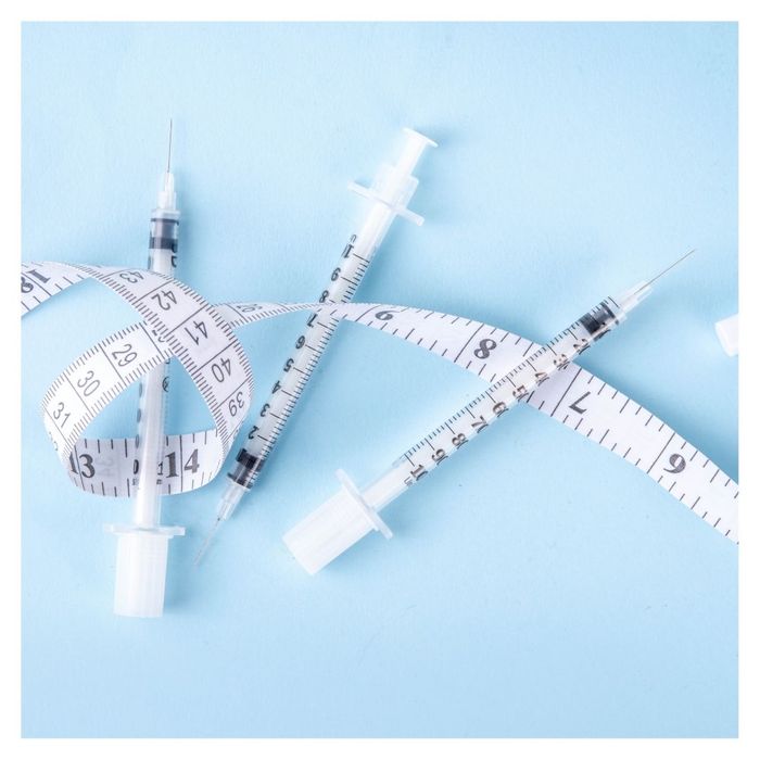 weight loss injection syringes and tape measure