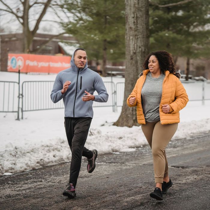 woman running with a man outside 