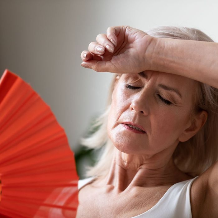 Lady with a fan and her hand on her head