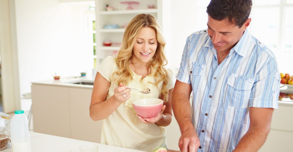 middle-aged couple eating healthy in the kitchen