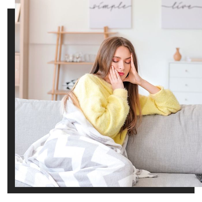 tired woman sitting on the couch