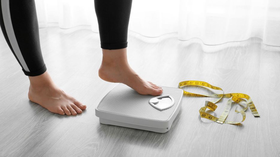 person stepping on scale 