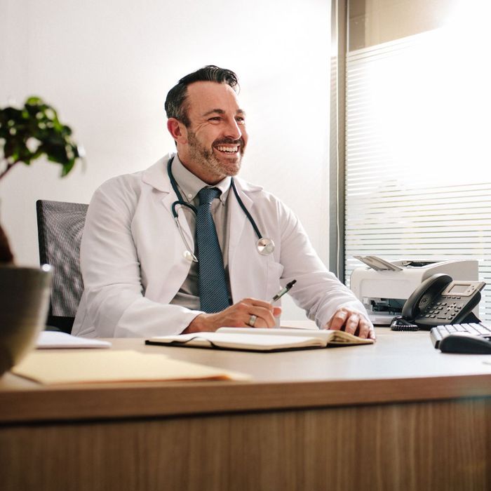 smiling doctor talks with patient