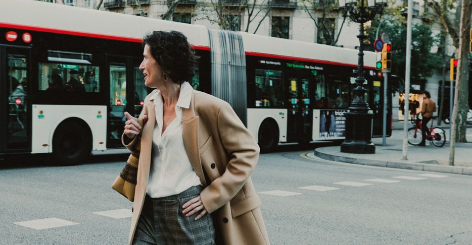 woman walking by bus