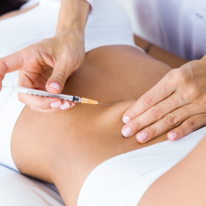A woman getting injections in her stomach