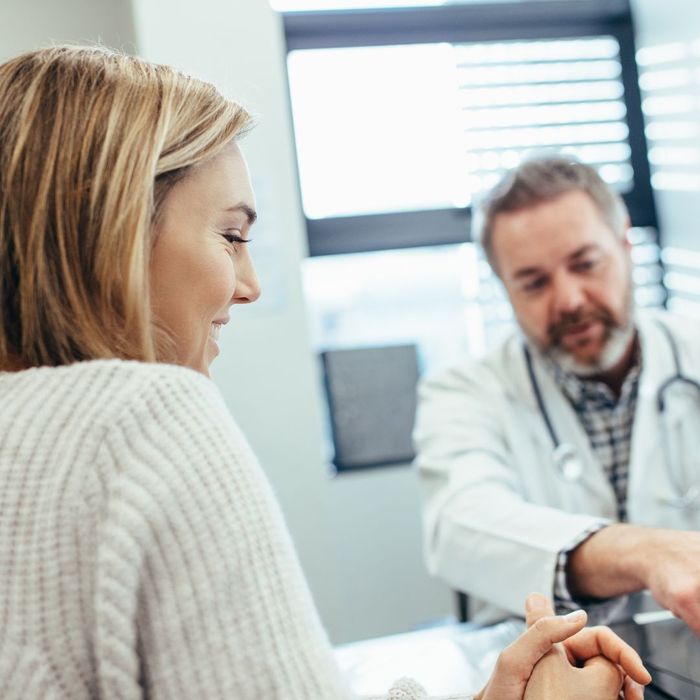 doctor talking with smiling patient