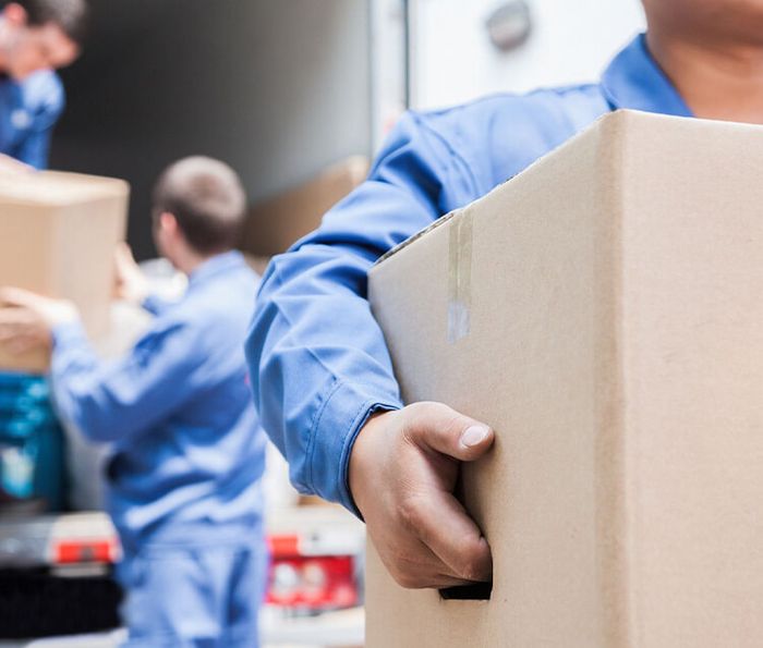 movers unloading boxes from a truck