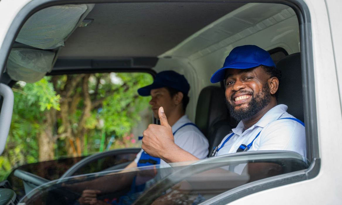 movers smiling in moving truck