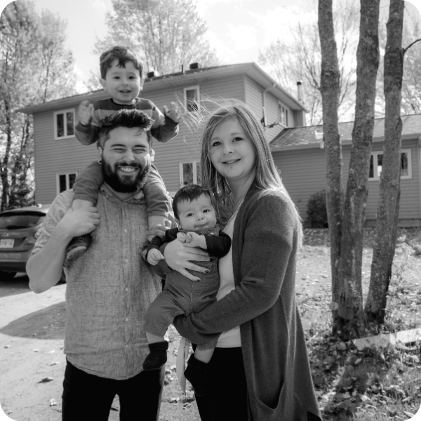 family standing outside of their home