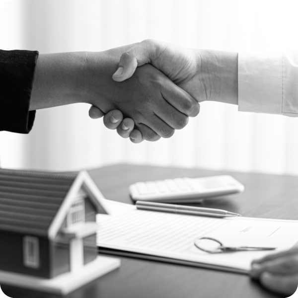 homeowner shaking hands with an insurance agent