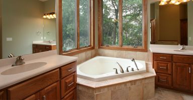 a bathroom with brown wooden cabinets a bathroom with brown wooden cabinets