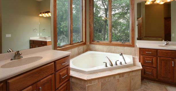 a bathroom with brown wooden cabinets