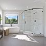 a glass shower with white tile