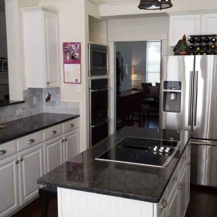 new black countertops, appliances and white cabinets