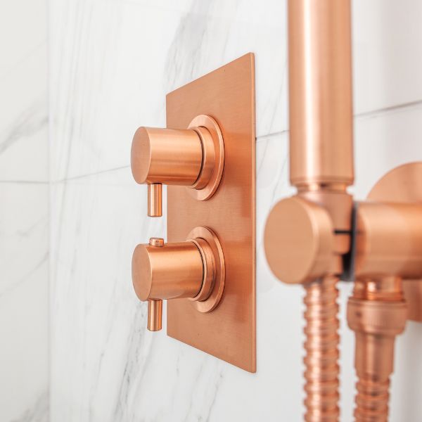 a shower with copper valves