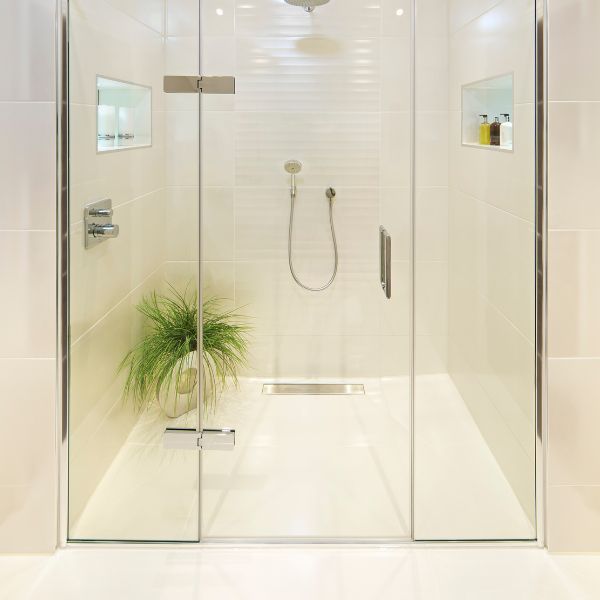 a flat shower with a glass door