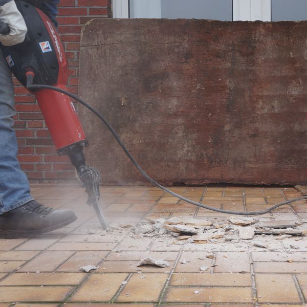 a person destroying tile flooring 