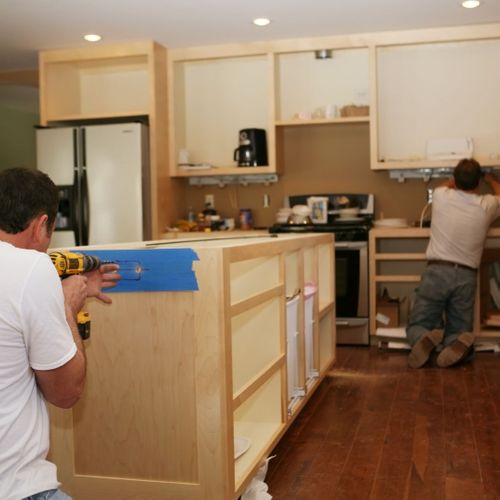 workers in the middle of a kitchen remodel