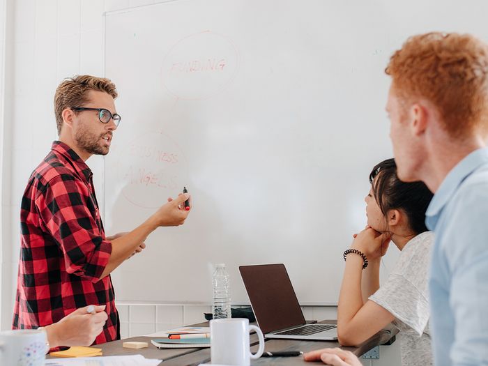 An image of four people working on a project.