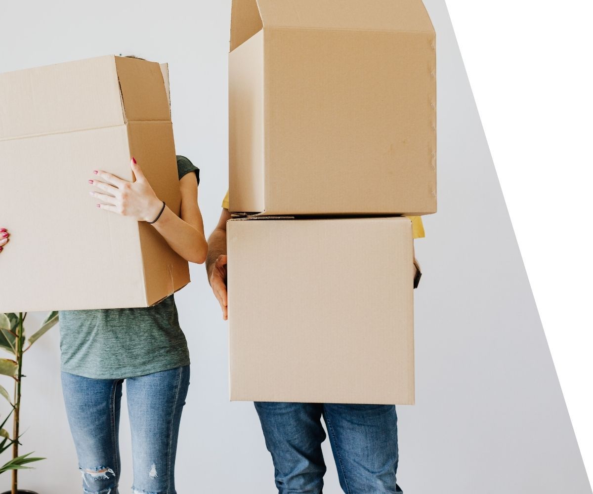 couple carrying moving boxes. 
