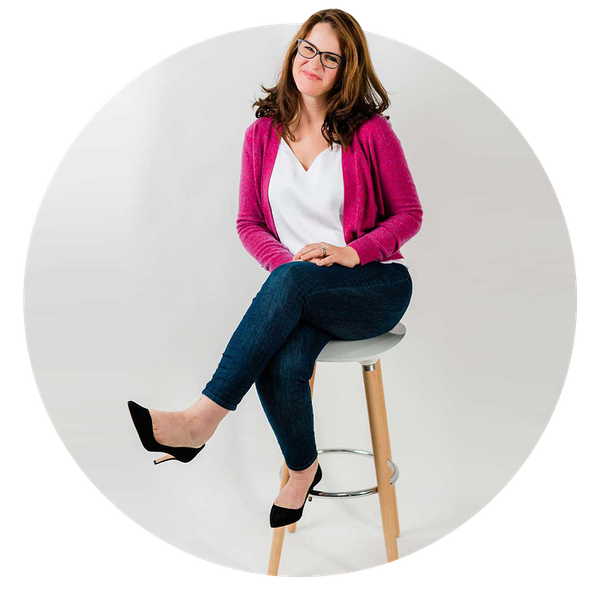 Rachael smiling while sitting on stool