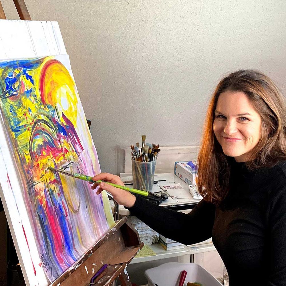 Rachael smiling while painting
