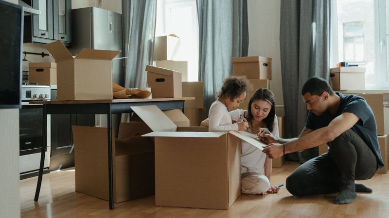 family packing moving boxes