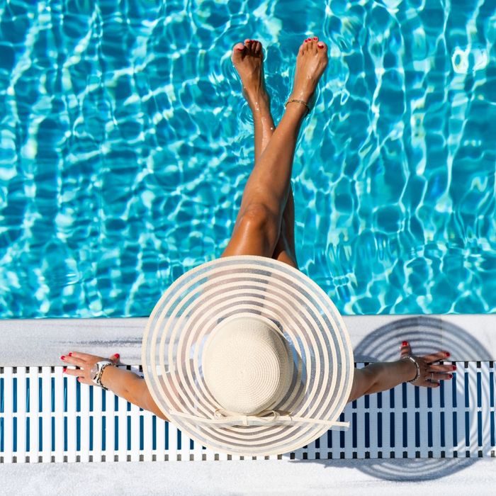 woman sitting by a pool