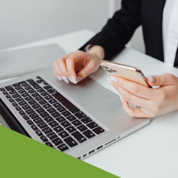 person using a laptop and phone