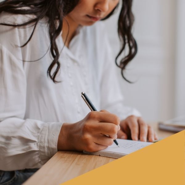 woman writing down notes