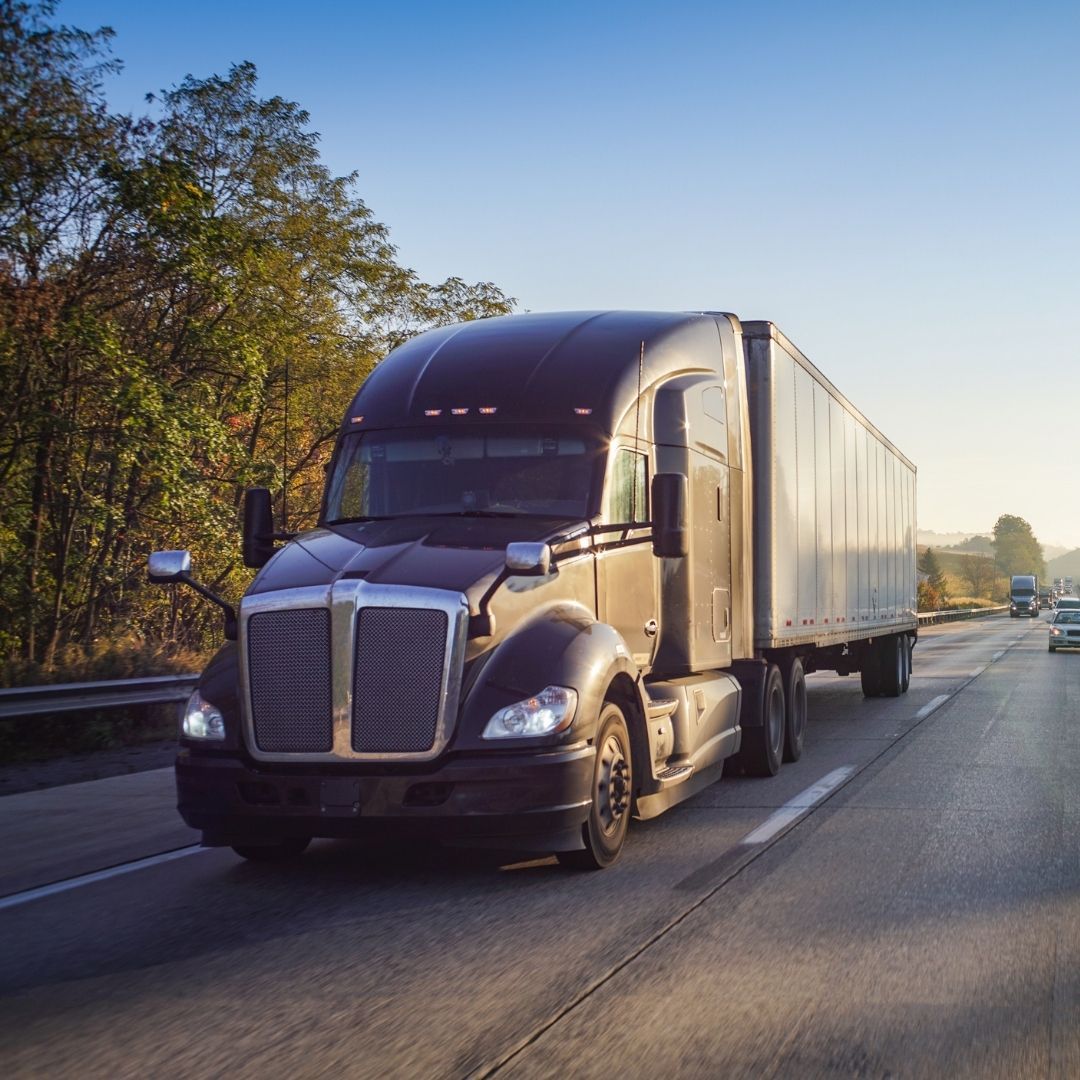 semi truck driving on highway during golden hour semi truck driving on highway during golden hour