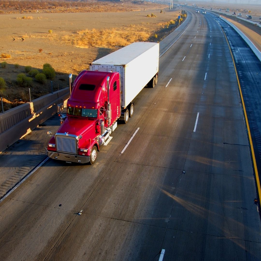 red semi truck driving on the road red semi truck driving on the road