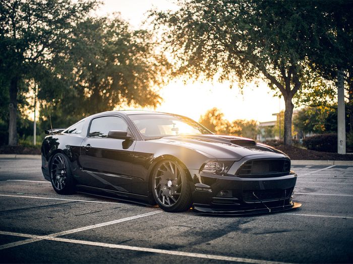 All black car parked in parking lot