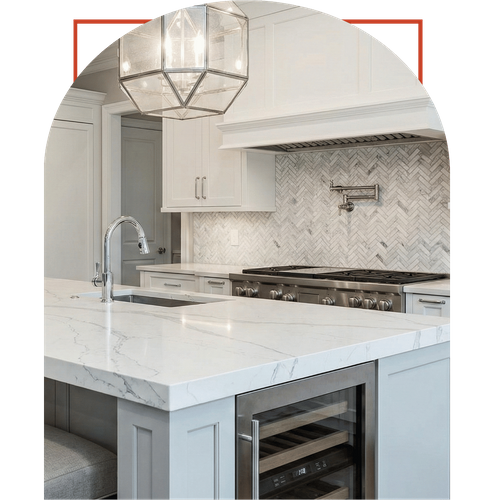 High-end kitchen renovation in Milton showcasing a white marble island with a built-in wine cooler and elegant geometric pendant lighting.