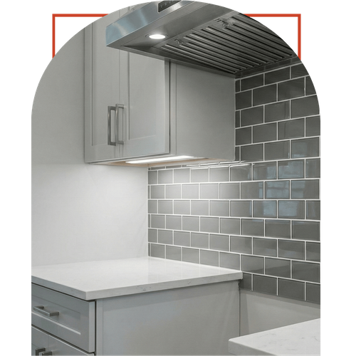 Close-up of a professional kitchen tile backsplash installation in Dawsonville featuring gray subway tiles and white quartz countertops.