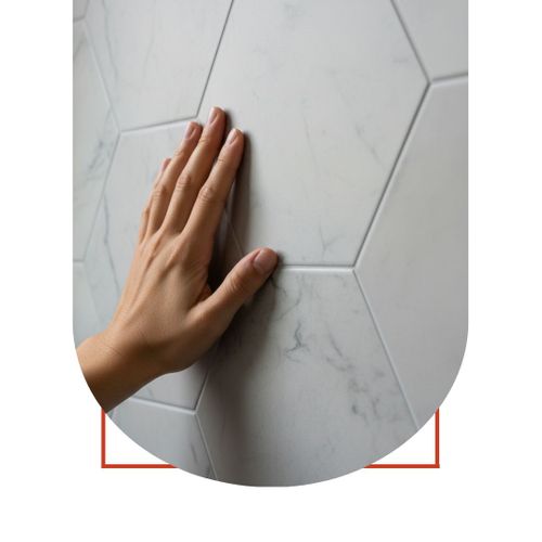 hand touching tile wall