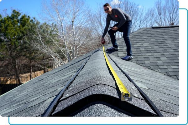 a man measuring a roof Roof Replacement (2).jpg