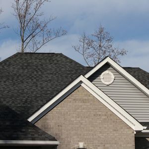 a home with a shingle roof Roofing Icon.jpg