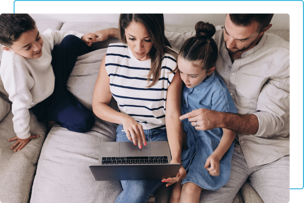 family on laptop in living room family on laptop in living room